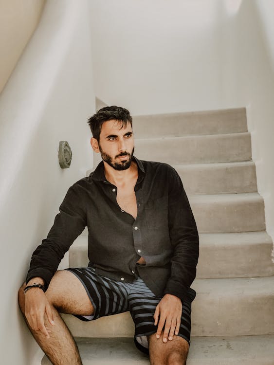 A Bearded Man in Black Long Sleeves Sitting on the Stairs · Free Stock ...