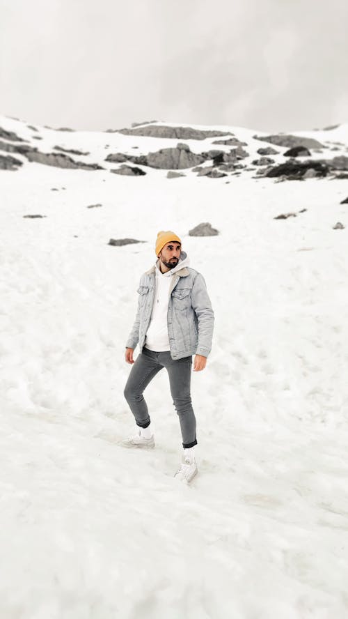 Man in a Denim Jacket Standing on White Snow