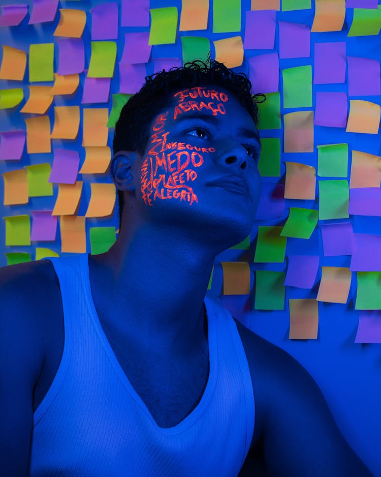 A Man Leaning His Head On The Wall With Sticky Notes