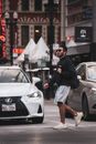 Man in Black Jacket and Brown Shorts Standing Beside Silver Mercedes Benz Car