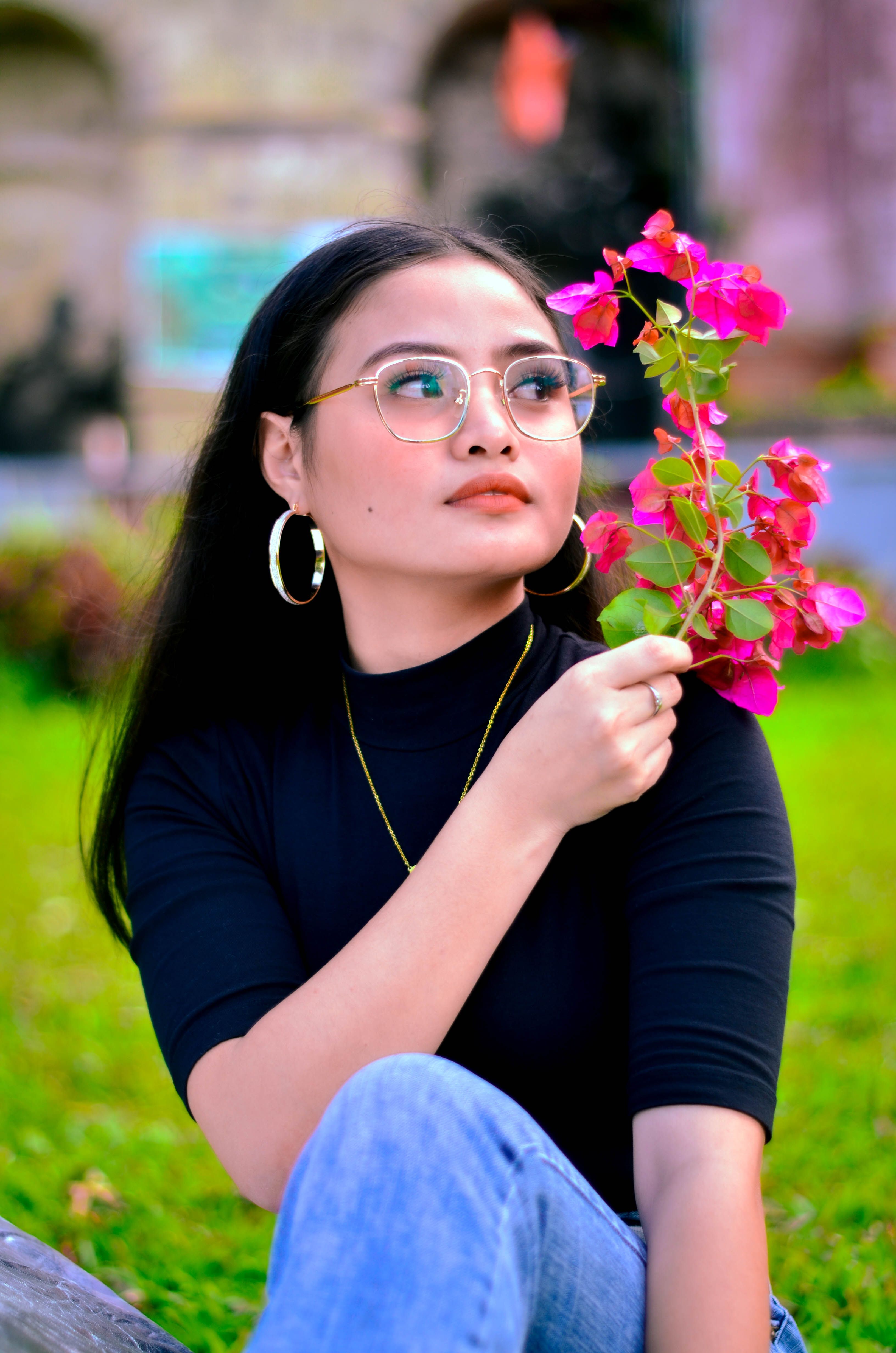 Woman in a Black Top Holding Bougainvillea Flowers · Free Stock Photo
