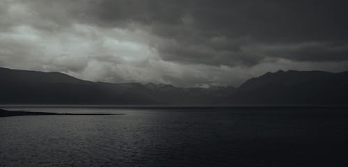 Grayscale Photo of the Lake and Mountains