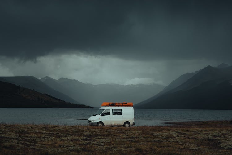 A Van Parked By A Lake