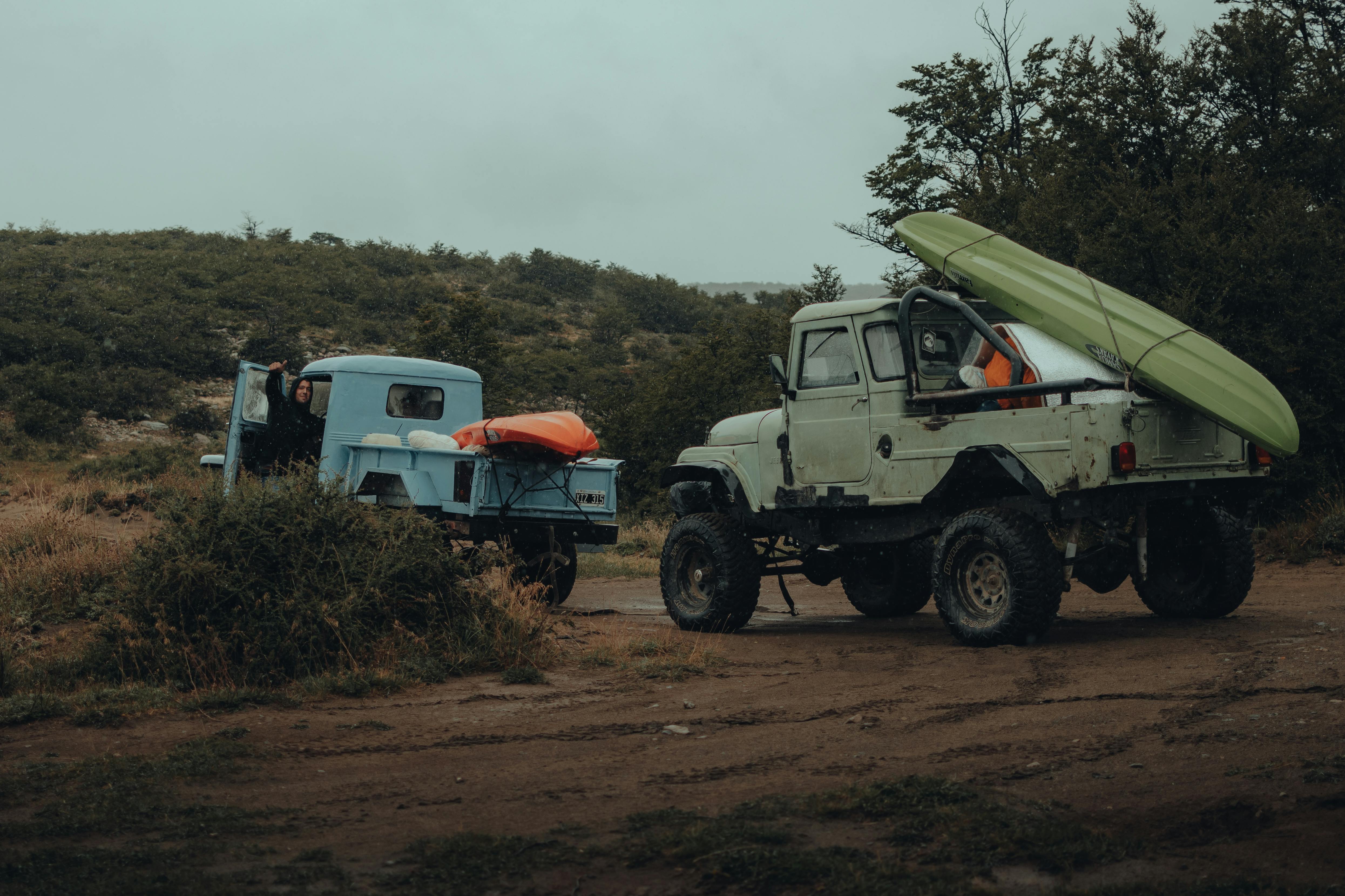 Various vehicles set up for camping showing SUVs, vans and trucks with different sleeping arrangements - automobile camping