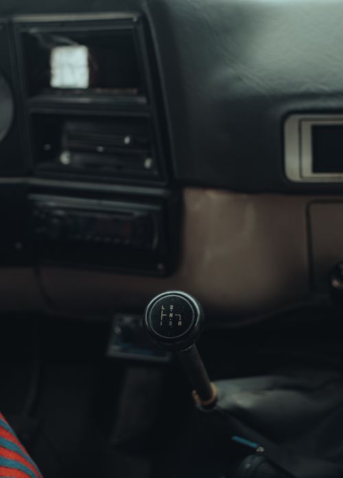 Free Close-up of a manual gear stick inside a vintage car, emphasizing the dashboard and controls. Stock Photo