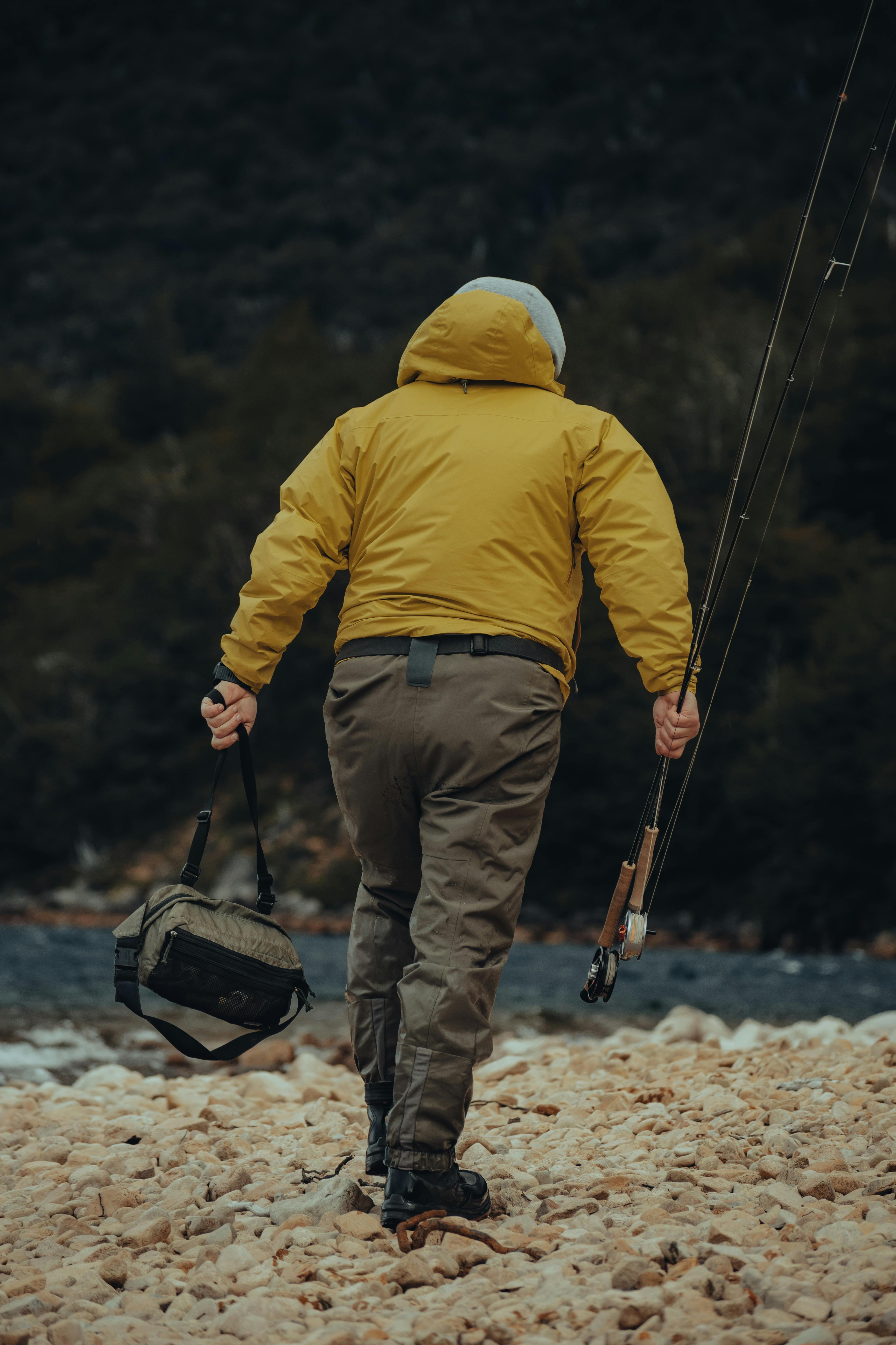 Man Walking On Beach With Fishing Equipment · Free Stock Photo