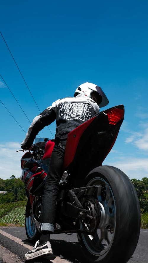 Free Man in White Helmet Riding Red Sports Bike Stock Photo