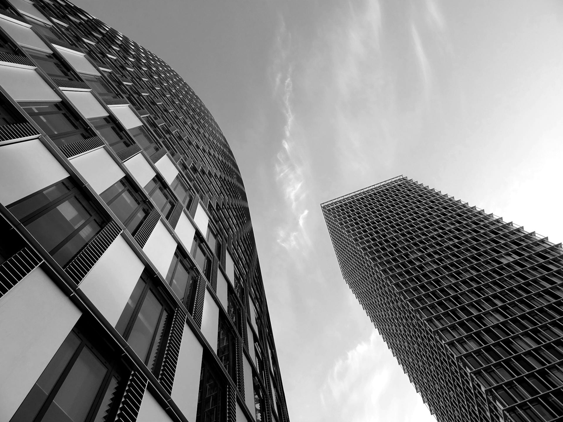 A striking black-and-white image of modern skyscrapers showcasing futuristic architecture and urban elegance.