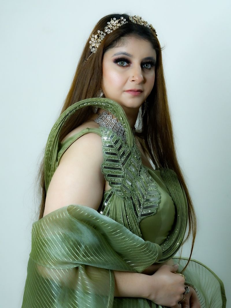 Woman in an emerald green beaded evening dress