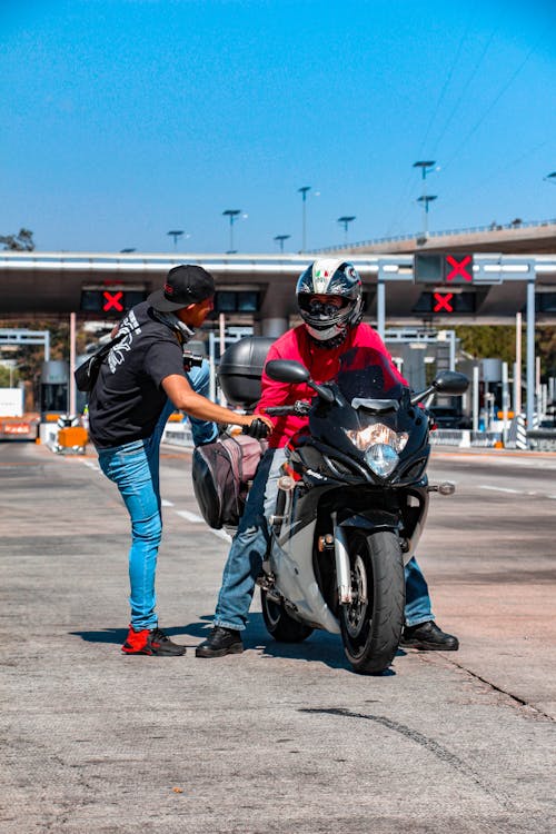 Man in Red Shirt Riding Motorcycle