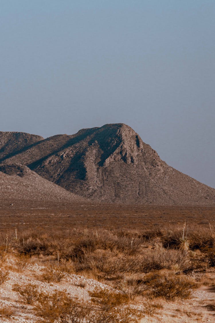 A Mountain Near The Grassy Field