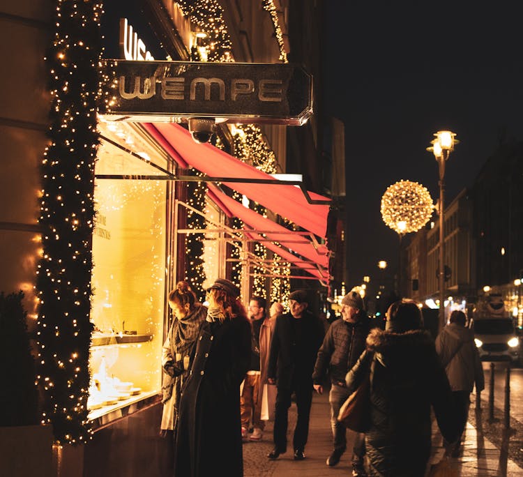 People Walking On The Street At Night