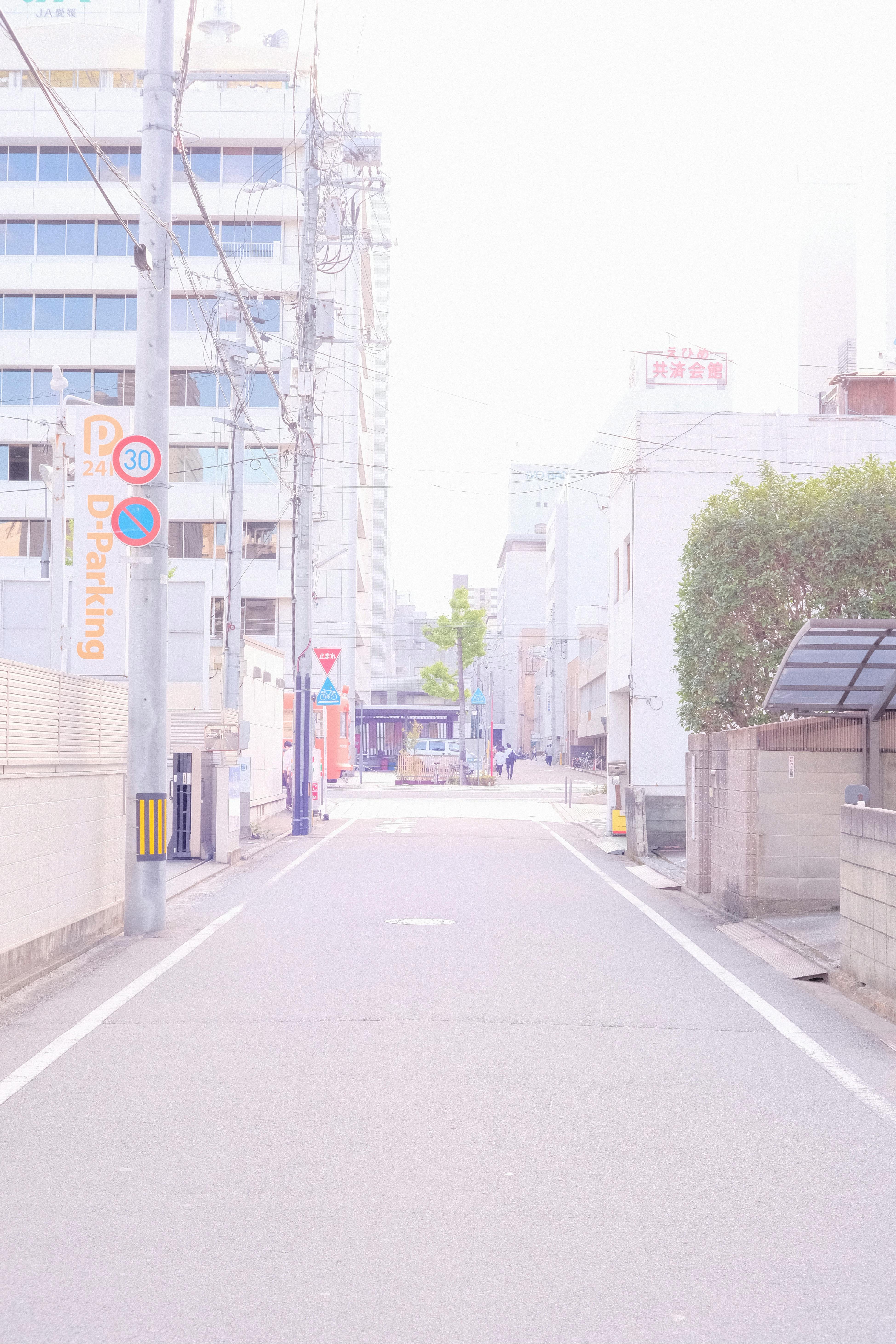 Gray Concrete Road Between Buildings · Free Stock Photo