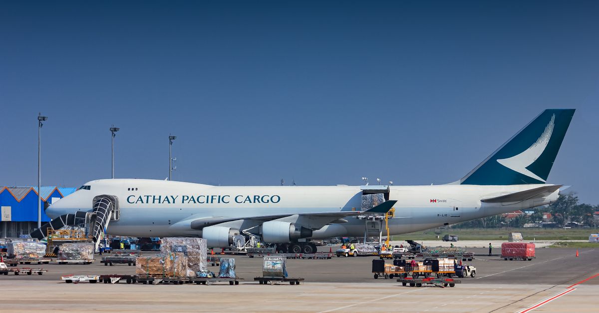 Cargo aircraft being loaded with freight at an airport