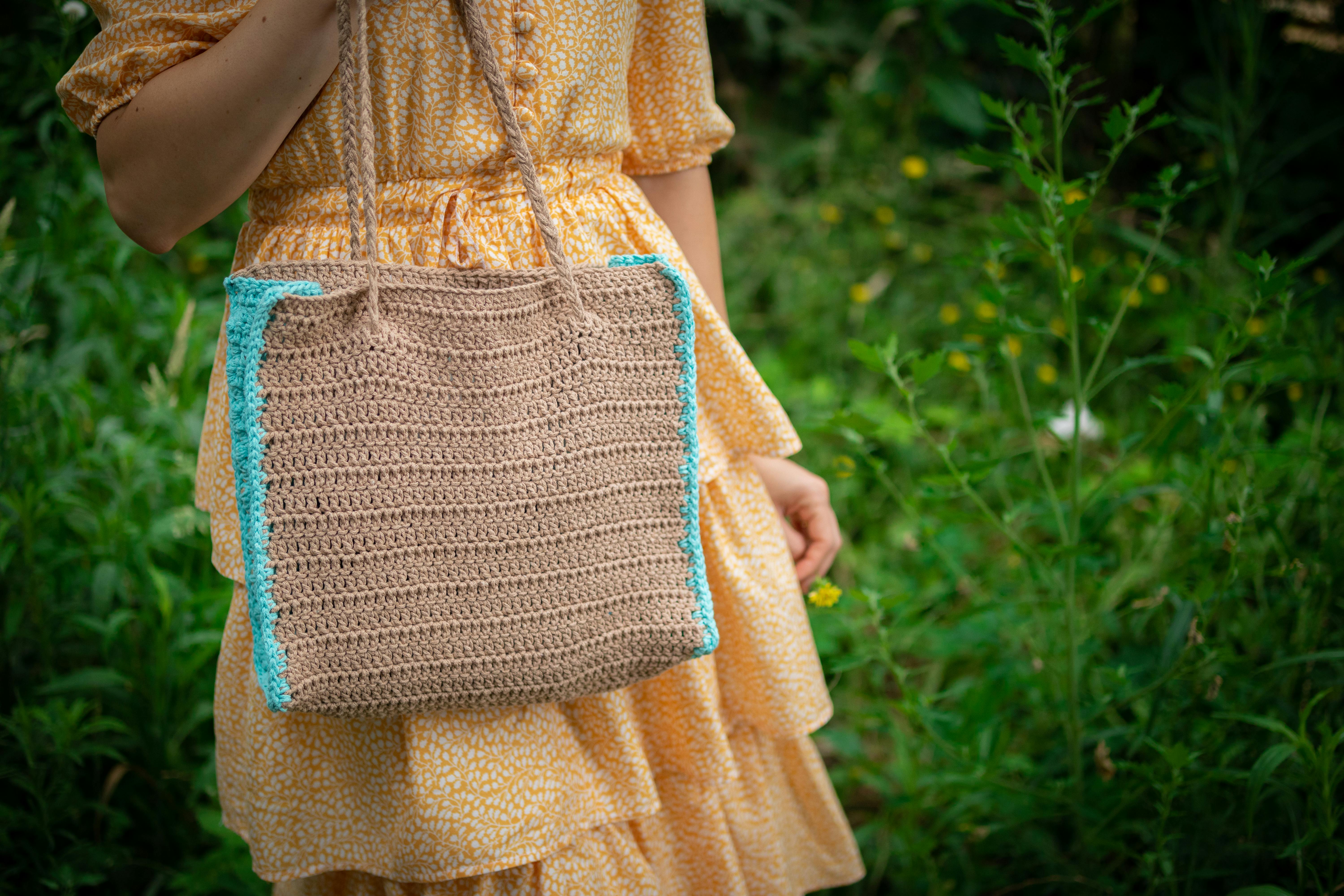 Photo of a Woman Holding a Knitted Bag