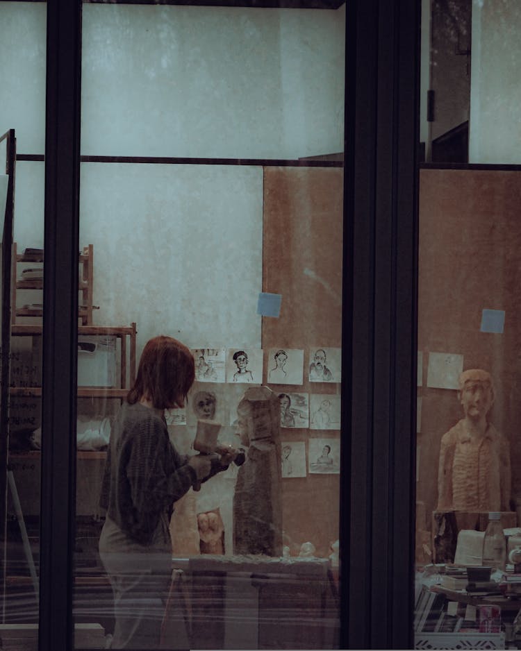 Woman Near Drawings On Wall