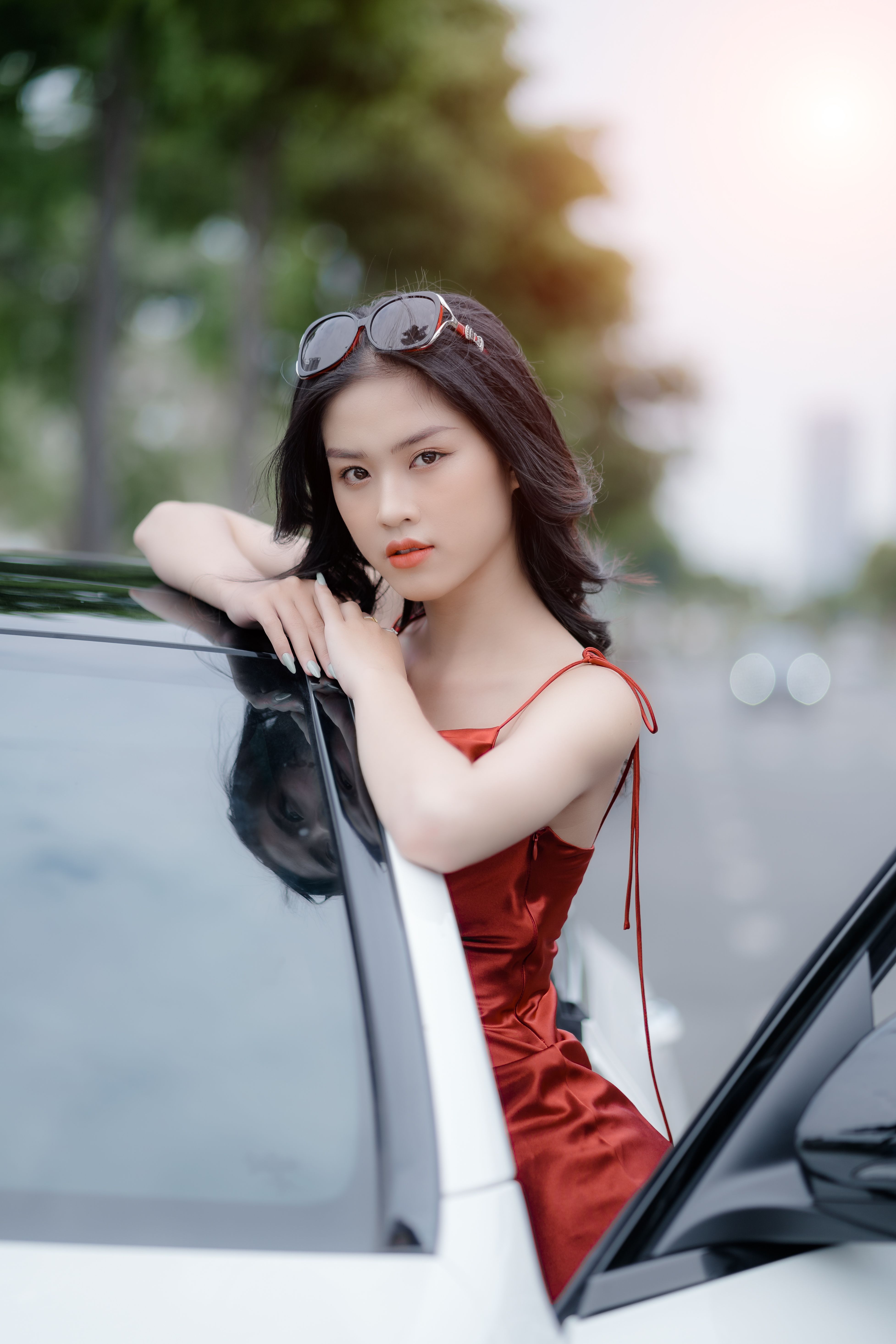 Woman in Red Sleeveless Dress Standing by the Car · Free Stock Photo
