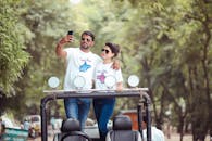 Photo of a Couple with Sunglasses Taking a Photo Together