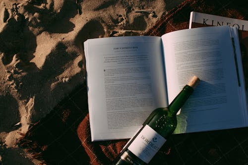 Free Green Glass Bottle on Book Page Stock Photo