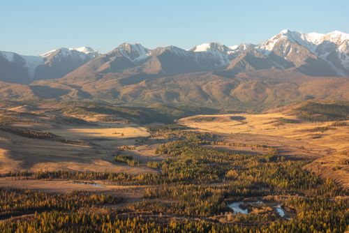 Free Golden hues illuminate the Altai Mountains at sunset, showcasing the rugged, majestic landscape of Russia. Stock Photo