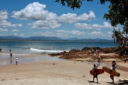 Free Surfers at the Beach Stock Photo