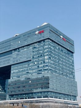 Striking view of a modern high-rise building in Beijing with clear blue sky backdrop.
