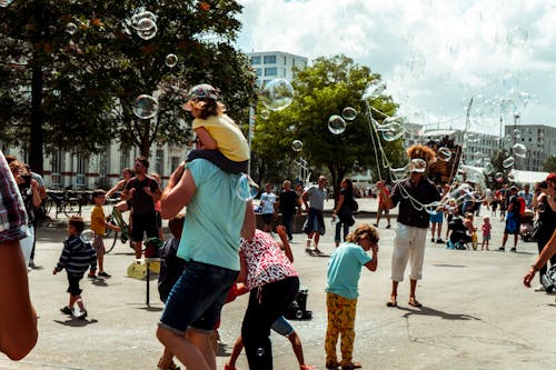 Free Photo of People Playing with Bubbles Stock Photo