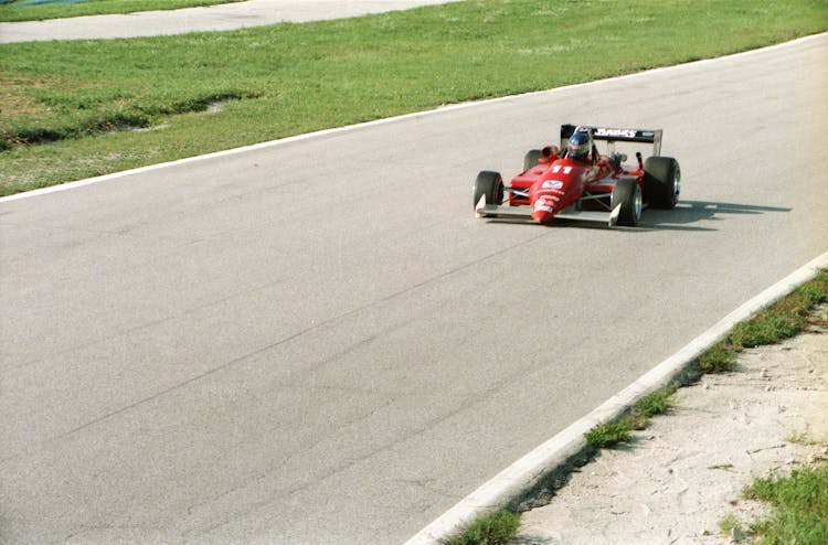 A Red Formula 1 Car In A Racetrack