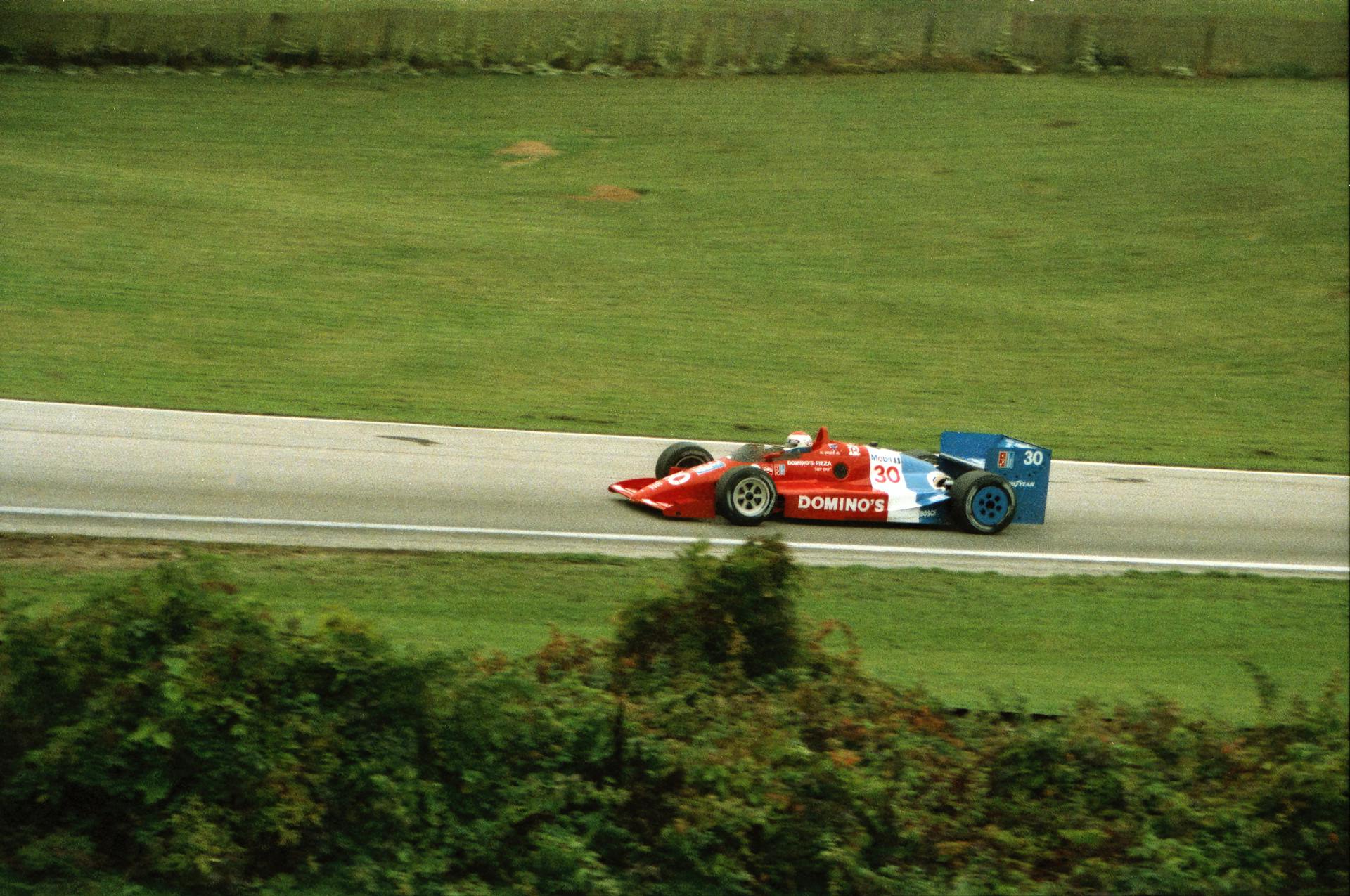 Race car speeding on the track at Elkhart Lake, Wisconsin. Captures the thrill of high-speed auto racing.