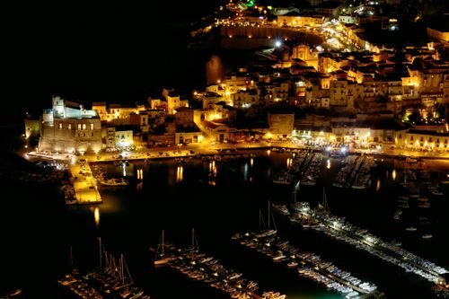 Free A mesmerizing night view of Castellammare del Golfo harbor illuminated in Sicily, Italy. Stock Photo