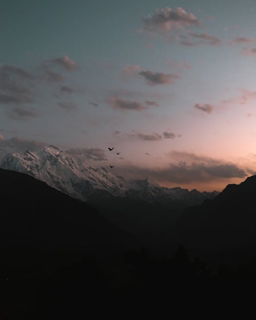 Free Drone Shot of a Snow Covered Mountain Stock Photo