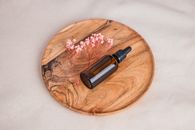 Black and Silver Bottle on Brown Wooden Round Table