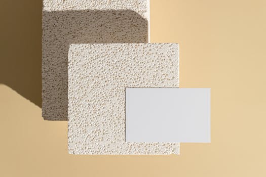 Simple minimalist mockup featuring a textured tile and blank card on a soft beige background.