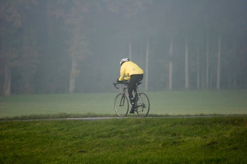 Free Photo of a Person Riding a Bicycle Near Grass Stock Photo
