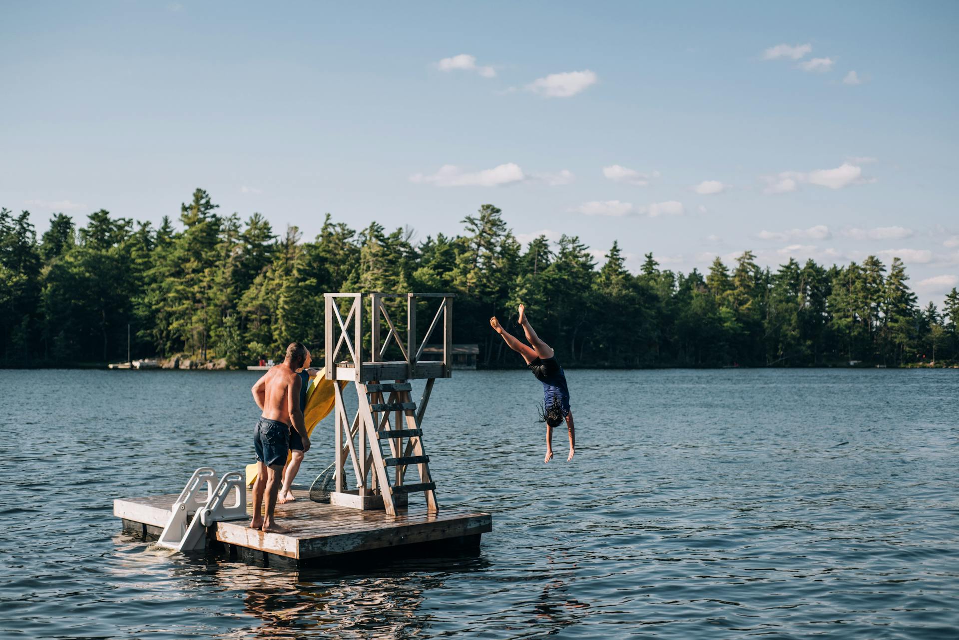 People Jumping into Lake