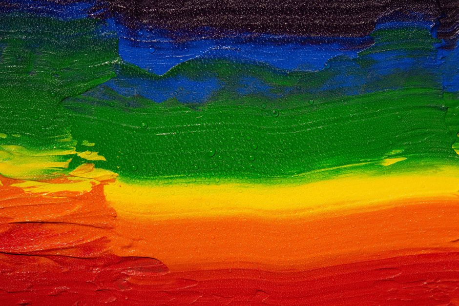 A vivid abstract painting showcasing rainbow colors with water droplets texture.