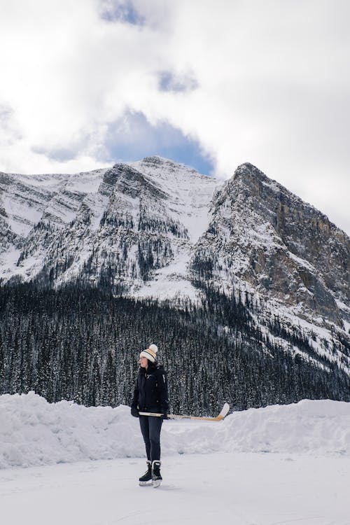 Free Woman Ice Skating in Mountains  Stock Photo