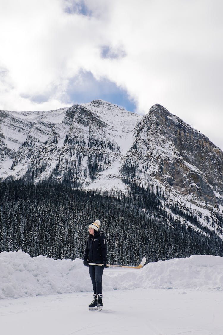 Woman Ice Skating In Mountains 