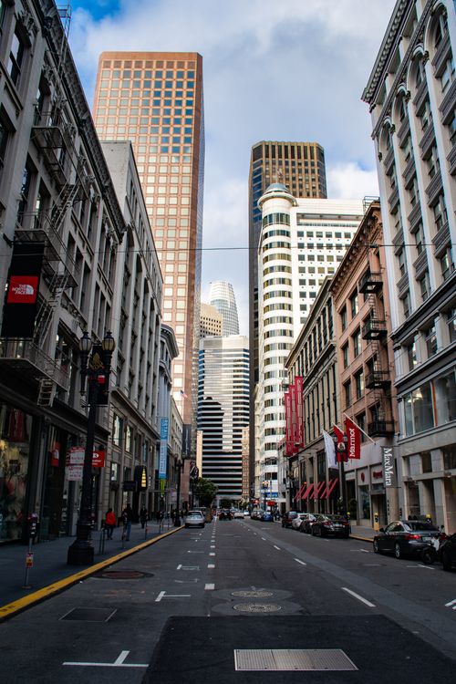 Free Dynamic city street lined with skyscrapers, capturing urban life and architecture. Stock Photo