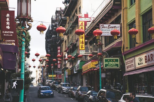Free Vehicles Parked Beside Buildings Under Red Chinese Lanterns Stock Photo