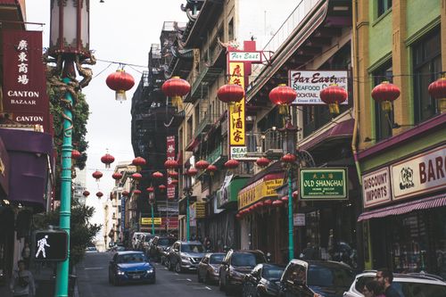 Free Bustling San Francisco Chinatown street with red lanterns and shops, capturing urban vibrancy. Stock Photo