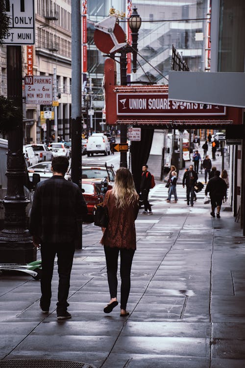無料 男と女が店の横を歩く 写真素材