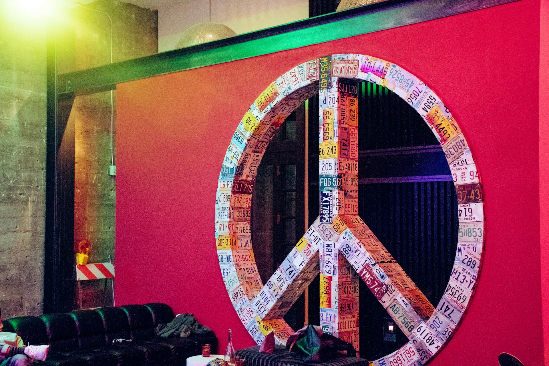 Red and Multicolored License Plate Covered Peace Sign Wall Decor