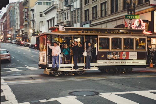 White and Black Bus Near White Building