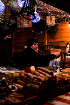 Winter market scene with holiday decorations and local food stalls during Christmas festivities.