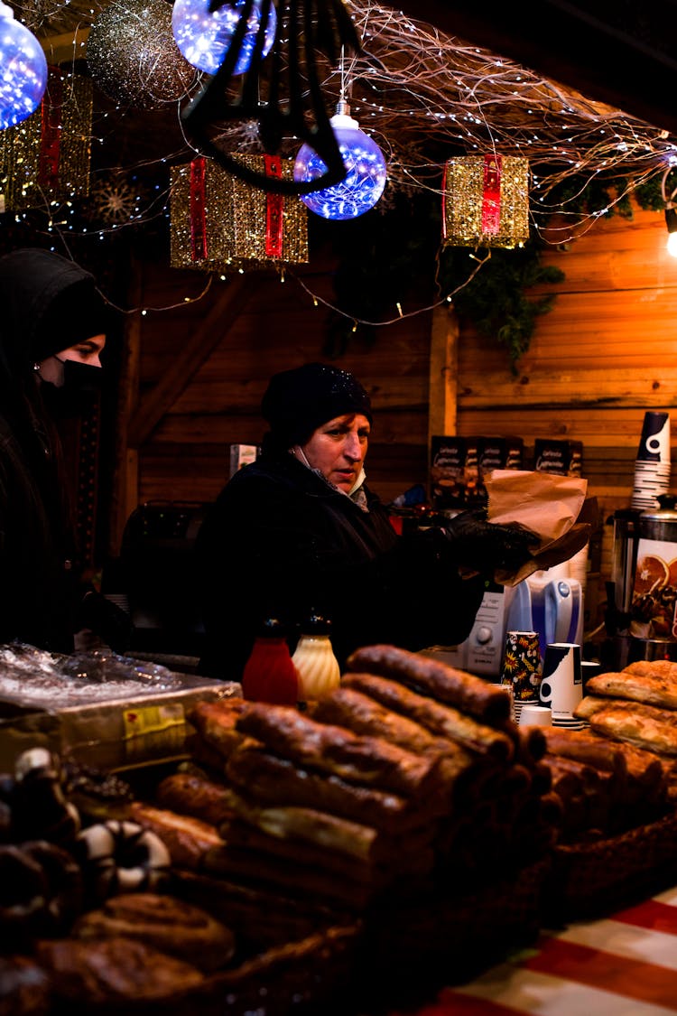 Woman Selling Local Food On Christmas Market 