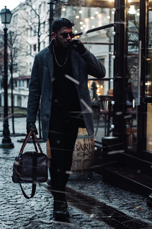 Photo of a Stylish Man Carrying a Duffle Bag