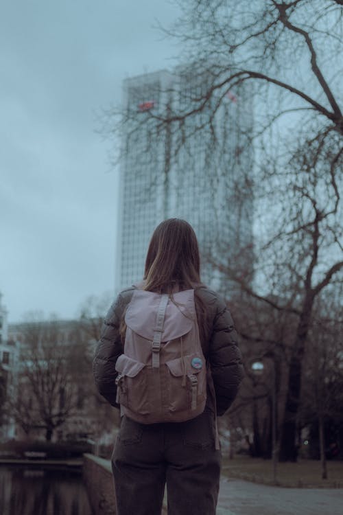 Free Woman with a Backpack Standing at a Park Stock Photo