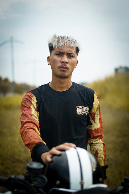 A Man Standing Beside a Motorbike