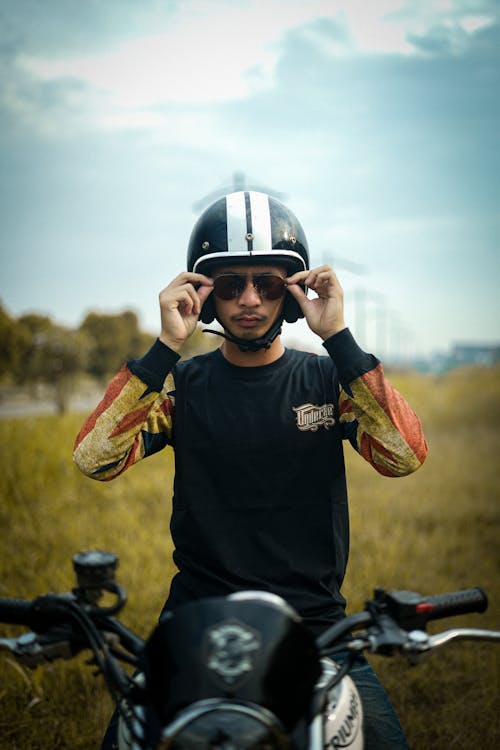 Man Wearing a Helmet Sitting on a Motorcycle